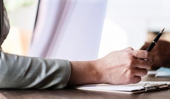 Sole Trader signing documents for sole trader loan brokered by QPF Finance Broker