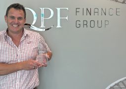 Chris Garner holds his 2022 CAFBA Emerging Broker of the Year Trophy