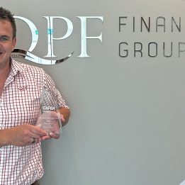 Chris Garner holds his 2022 CAFBA Emerging Broker of the Year Trophy