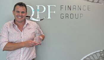 Chris Garner holds his 2022 CAFBA Emerging Broker of the Year Trophy