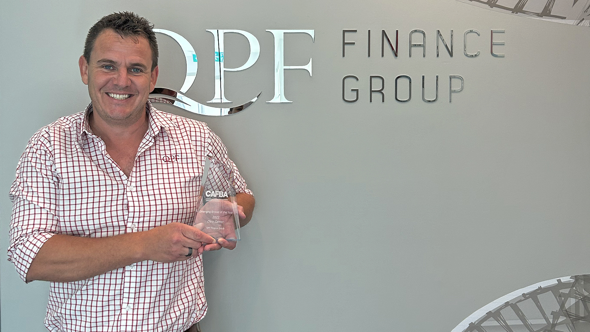 Chris Garner CAFBA Emerging 2022 Award Chris Garner holds his 2022 CAFBA Emerging Broker of the Year Trophy