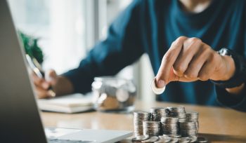 Man hands putting coins stack, Concept business finance saving money, funding and investment.